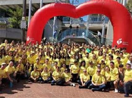 Image of EY employees at the Heart Walk with matching yellow shirts